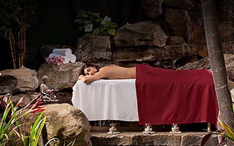 a woman enjoying a massage outside in a serene setting