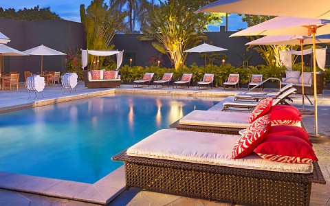 pool and lounge chairs at night 
