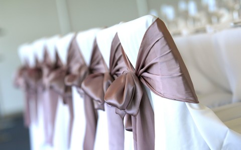 close up of chairs dressed for an event 