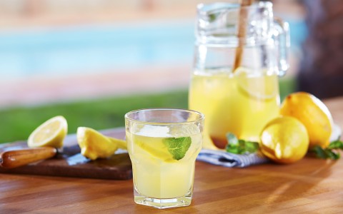 a fresh pitcher and a cup of lemonade 